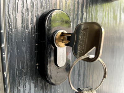 A close-up of a locking mechanism with a key inserted in the door lock